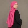 Model wearing a hot pink Kuwait jersey hijab